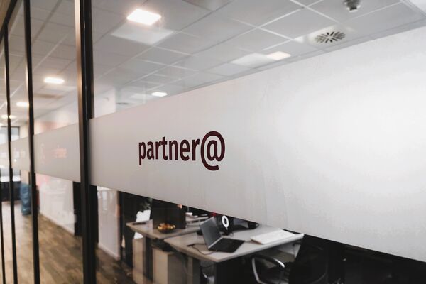 Glaswand mit transparenter Aufschrift partner@